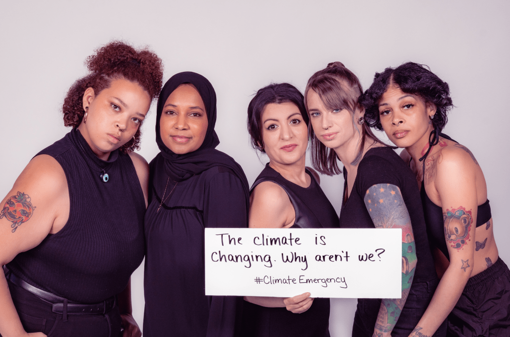 People of different backgrounds and races holding a sign saying "The climate is changing. Why aren't we?"